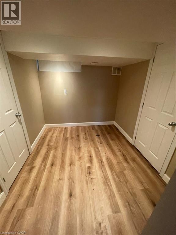 Finished basement with light wood-type flooring - 124 Avalon Place, Kitchener, ON