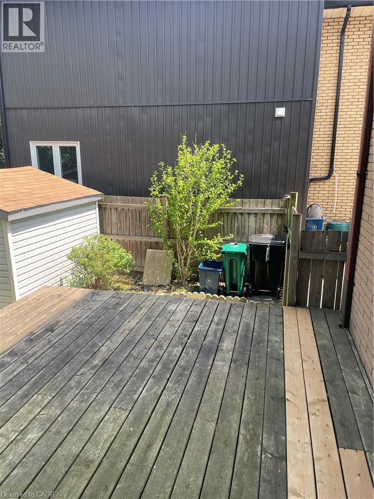 Wood deck with partial new boards, fenced perimeter, and a detached storage shed - 124 Avalon Place, Kitchener, ON