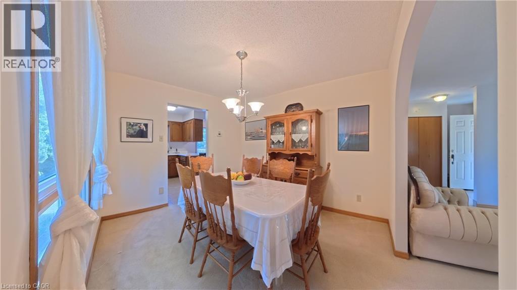 Light-colored walls with trim, overhead chandelier, and an arched entry - 56 Scenic Wood Crescent, Kitchener, ON