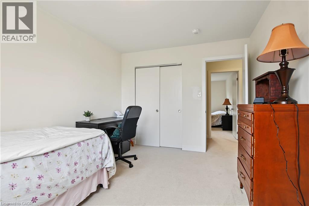 Neutral carpet flooring, white walls, and white bi-fold closet doors - 1444 Upper Ottawa Street Unit# 32, Hamilton, ON