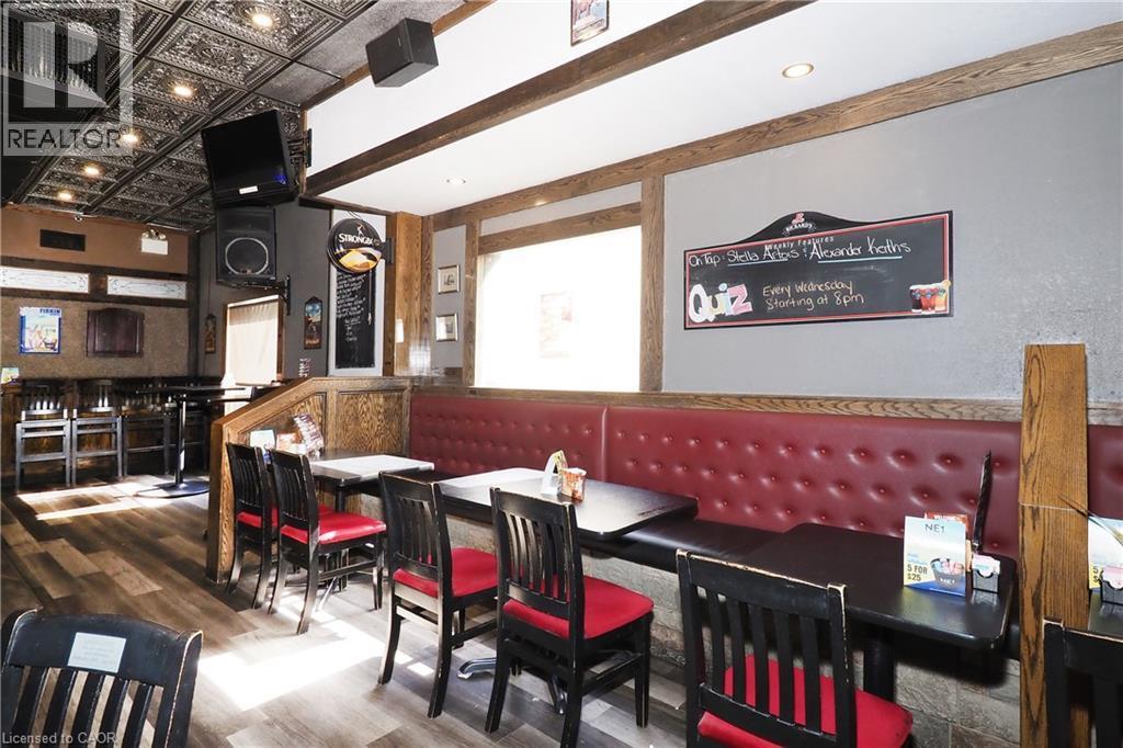 Wood-finish flooring throughout, complemented by exposed wood beams - 707 E King Street E, Cambridge, ON