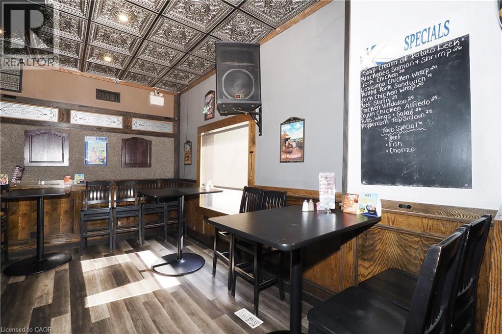 Wood-finish flooring, dark wood wainscoting, and an embossed ceiling with recessed lighting - 707 E King Street E, Cambridge, ON