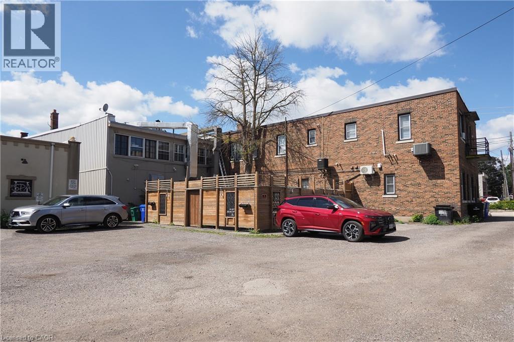 Gravel parking area accommodating multiple vehicles - 707 E King Street E, Cambridge, ON