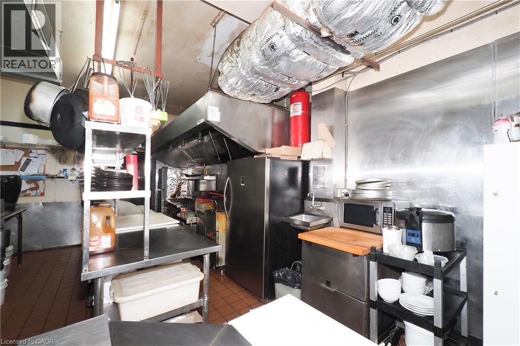 Stainless steel wall paneling, tile flooring, and integrated stainless steel countertops - 707 E King Street E, Cambridge, ON