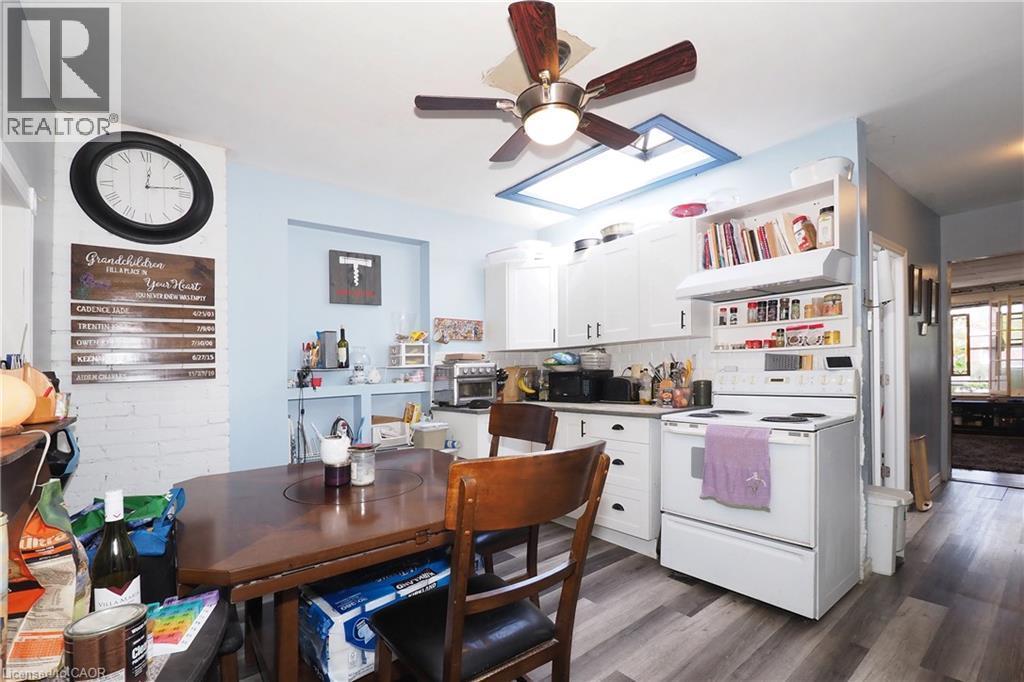 Kitchen featuring white cabinetry, wood-finish flooring, a ceiling fan, and recessed lighting - 707 E King Street E, Cambridge, ON