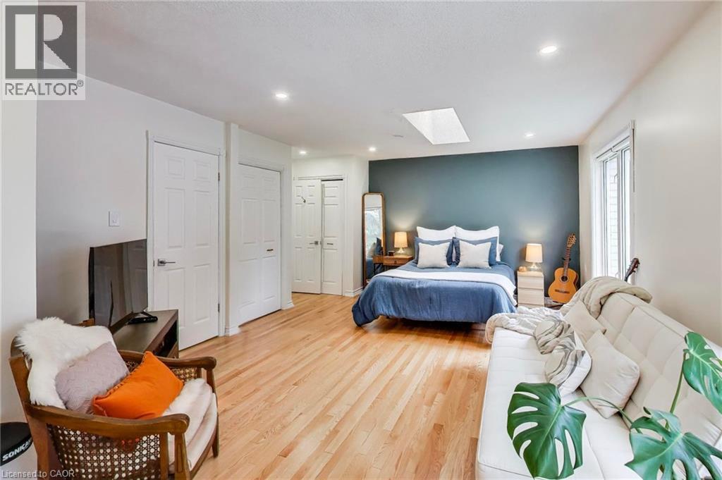 Wood-finish flooring, recessed lighting, skylight, multiple paneled doors, and a large window - 35 Shirlea Boulevard, Keswick, ON