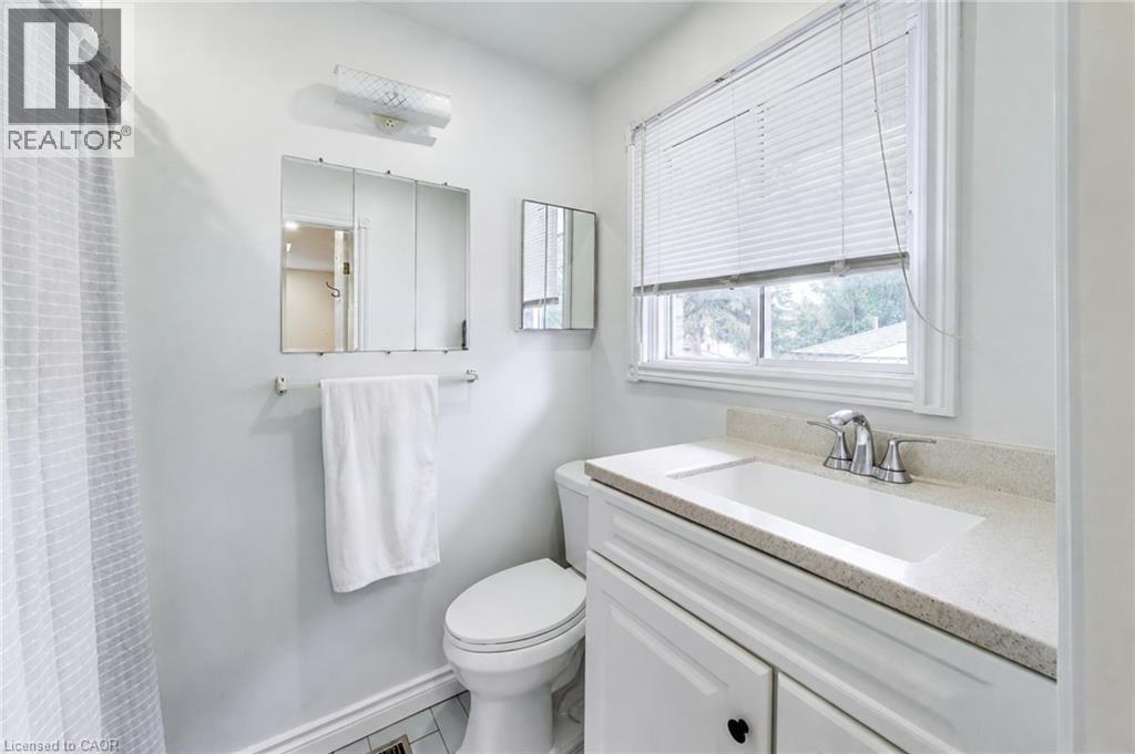 White single vanity with integrated sink, chrome faucet, and light-toned countertop - 35 Shirlea Boulevard, Keswick, ON