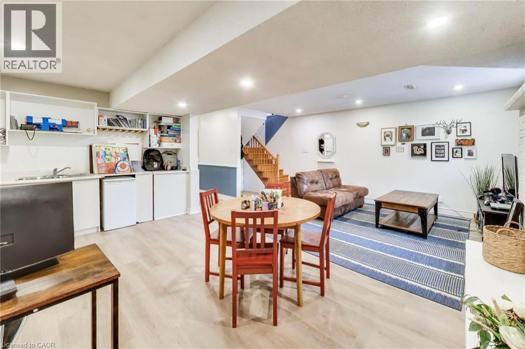 Light wood-finish flooring, recessed lighting, built-in lower cabinetry, a built-in sink, and wood staircase - 35 Shirlea Boulevard, Keswick, ON
