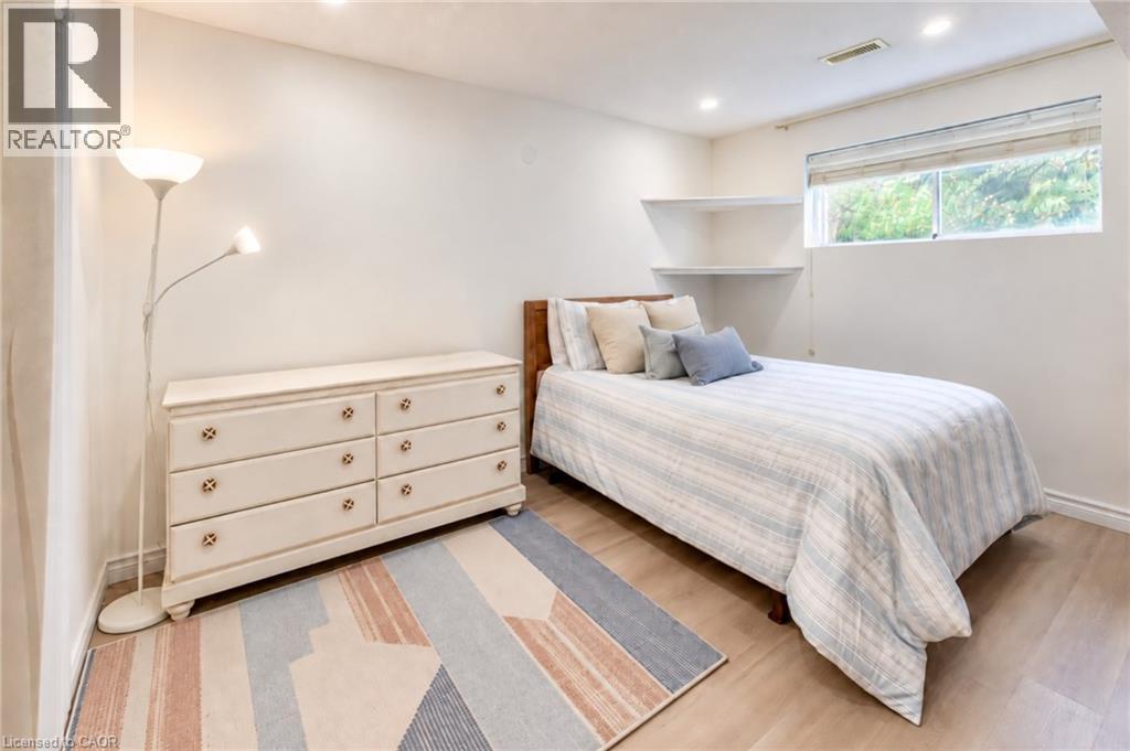 Wood-finish flooring, recessed lighting, and wall-mounted shelving enhance this room - 35 Shirlea Boulevard, Keswick, ON