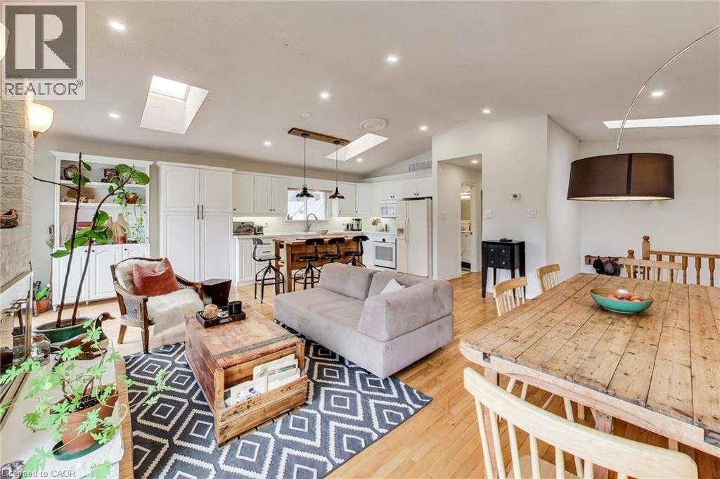 Hardwood flooring throughout, featuring recessed lighting, skylights, white cabinetry, and an open-concept layout - 35 Shirlea Boulevard, Keswick, ON