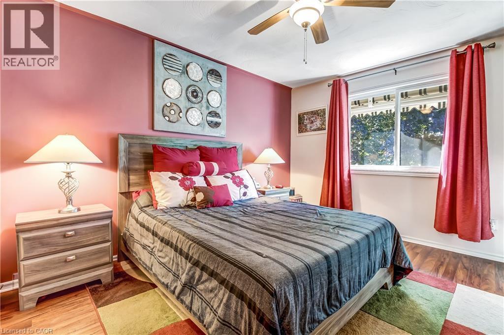 Wood-finish flooring, ceiling fan, and large window with blinds - 150 Oak Street Unit# 27, Simcoe, ON
