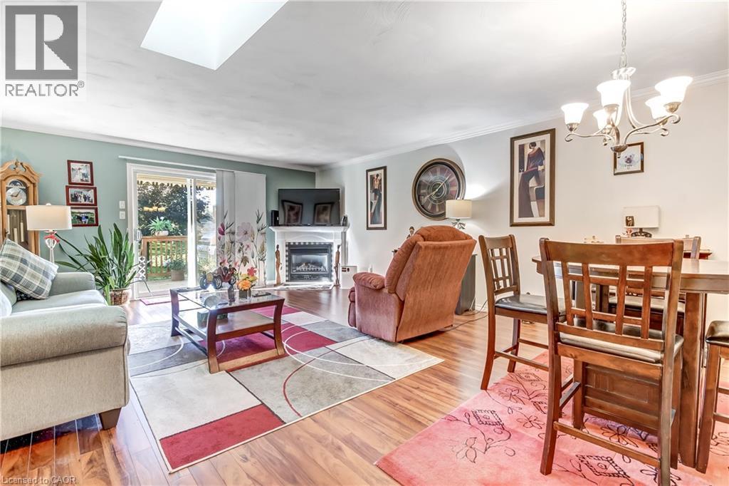 Wood-finish flooring throughout, with a recessed ceiling light and a skylight - 150 Oak Street Unit# 27, Simcoe, ON