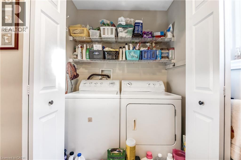 Laundry closet featuring bi-fold doors, wire shelving, and overhead lighting - 150 Oak Street Unit# 27, Simcoe, ON