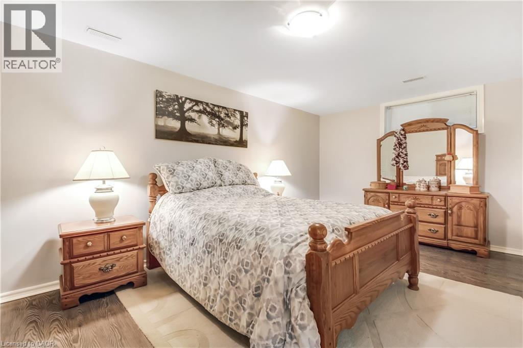 Neutral wall paint, wood-finish flooring, and overhead lighting - 150 Oak Street Unit# 27, Simcoe, ON