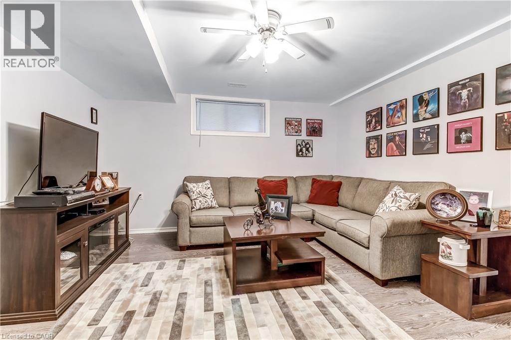 Recessed lighting with a ceiling fan, wall-mounted window, wood-finish flooring, and light-toned walls - 150 Oak Street Unit# 27, Simcoe, ON