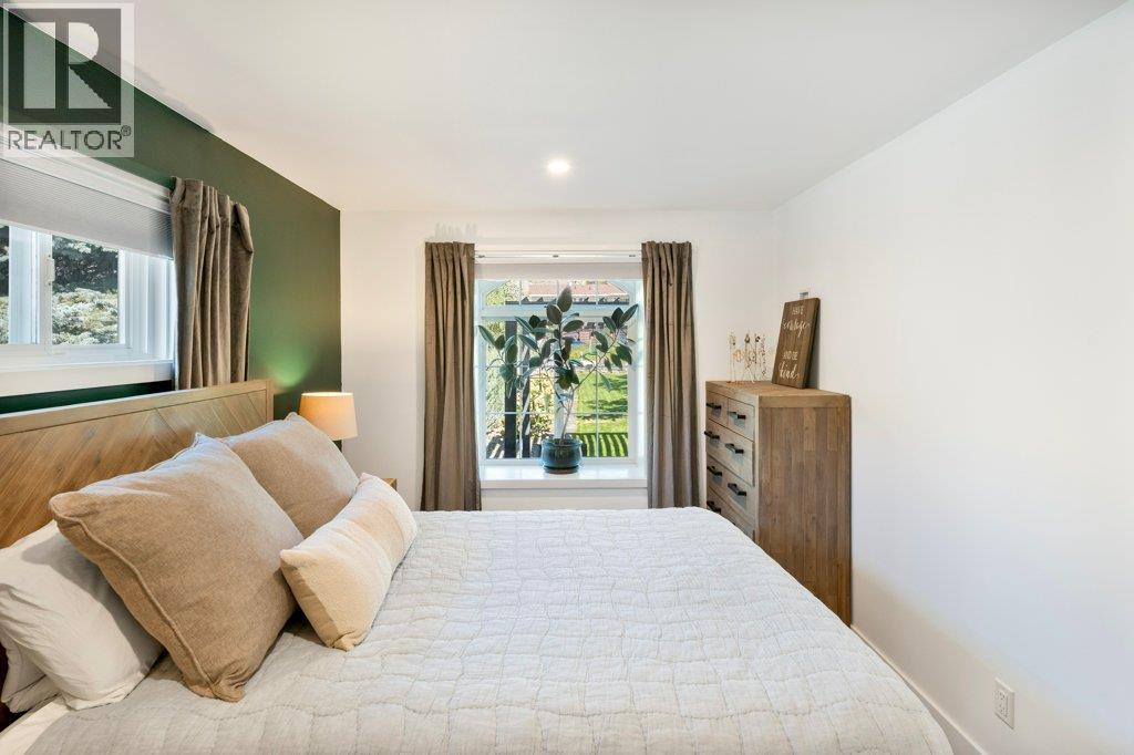 Primary bedroom with beautiful view window to back yard - 886 Fairview Road, Oliver, BC