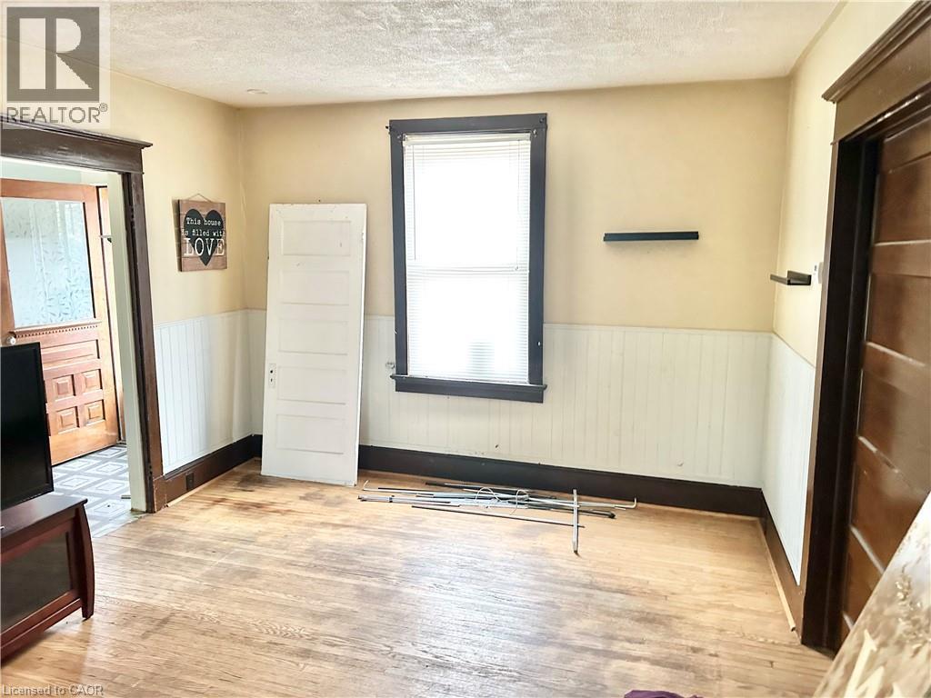 Wood-finish flooring with wainscoting and dark trim - 128 Kent Street S, Simcoe, ON