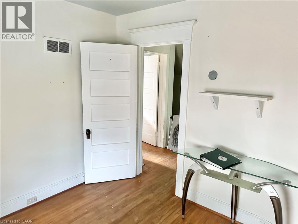 Bedroom another angle , white paneled door, door casing, wall shelf, and wall outlet - 128 Kent Street S, Simcoe, ON