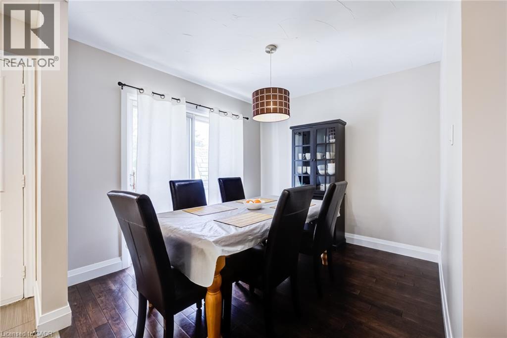 Dark wood-finish flooring, white wall paint, crown molding, and a drum pendant light fixture - 2037 Mountain Grove Avenue, Burlington, ON
