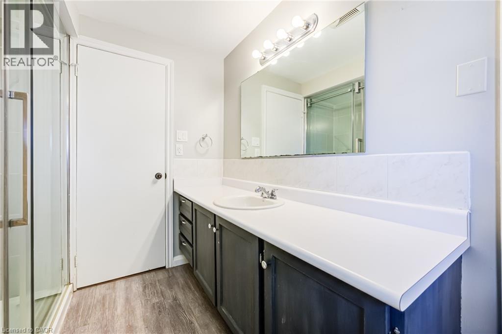 Vanity with integrated sink, chrome faucet, and dark wood-finish cabinetry - 2037 Mountain Grove Avenue, Burlington, ON