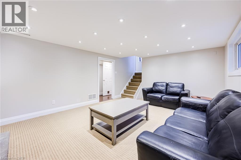 Recessed ceiling lighting, light-toned carpeting, a light gray wall color, white trim, and a window - 2037 Mountain Grove Avenue, Burlington, ON