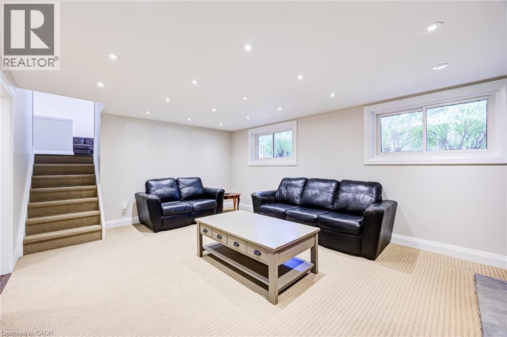 Recessed lighting throughout, two windows with white trim, and a carpeted staircase - 2037 Mountain Grove Avenue, Burlington, ON