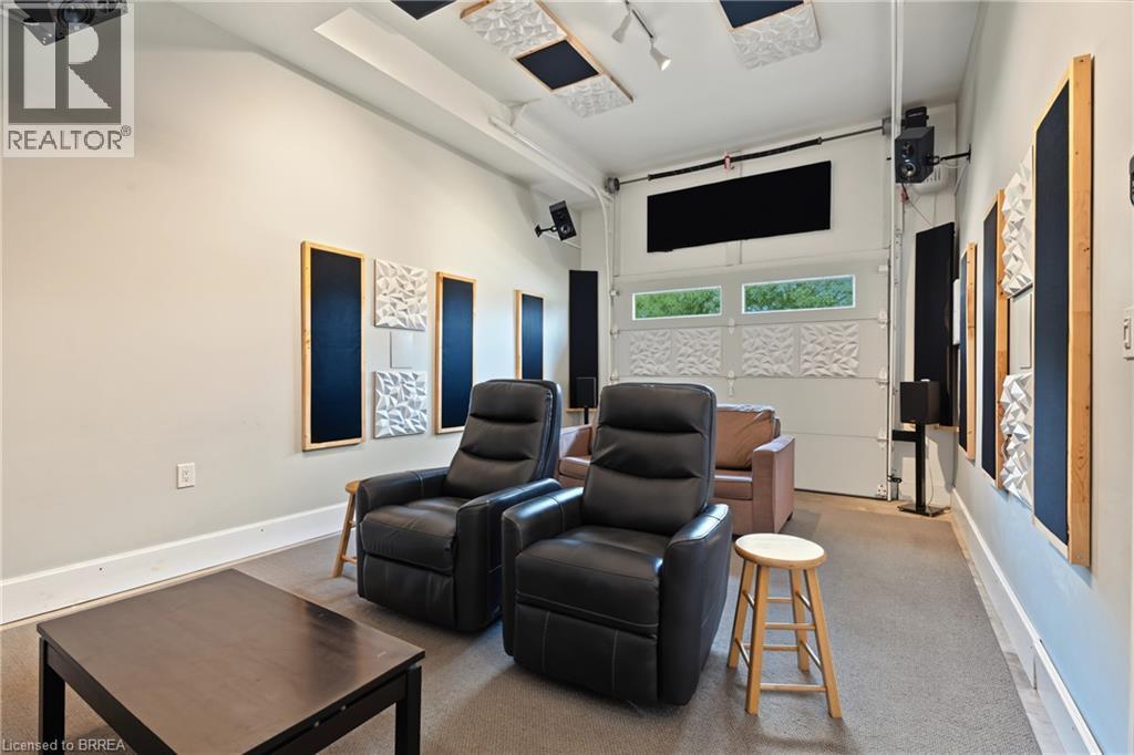 Media room featuring integrated sound panels, built-in ceiling speakers, and carpet flooring - 332 Grand River Avenue, Brantford, ON