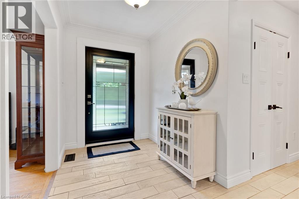 Entryway featuring a decorative transom door, light-toned tile flooring, and crisp white walls - 7 Shadywood Lane, Cambridge, ON