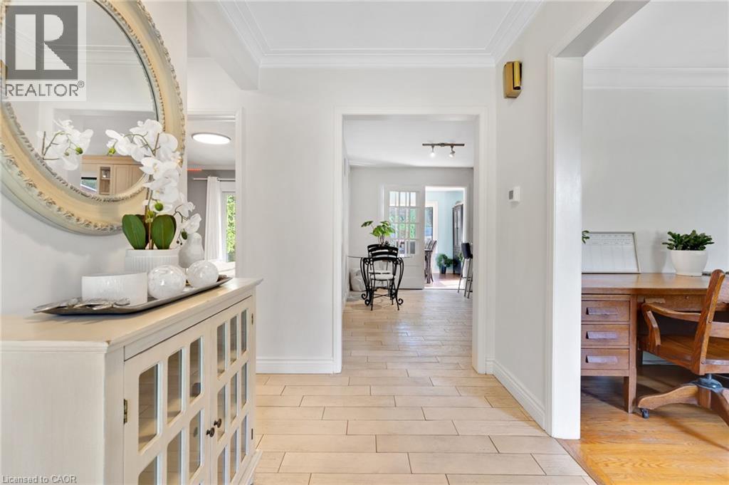 Crown molding, light-colored walls, wood-finish flooring, and arched doorways - 7 Shadywood Lane, Cambridge, ON