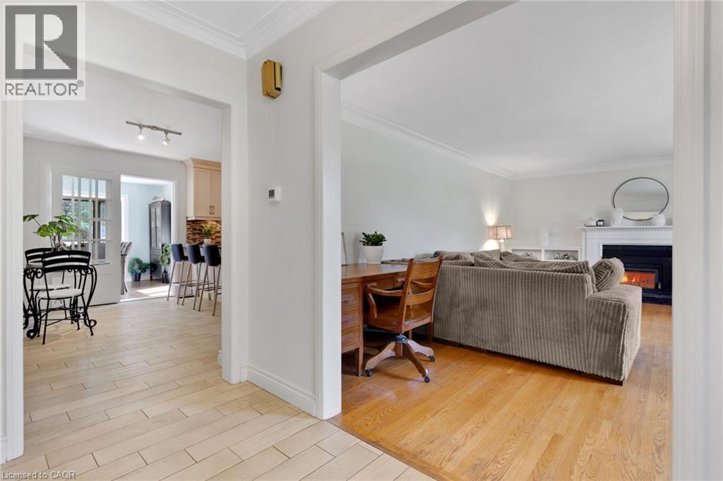 Hardwood flooring, crown molding, fireplace with mantel, French doors, and tile flooring - 7 Shadywood Lane, Cambridge, ON