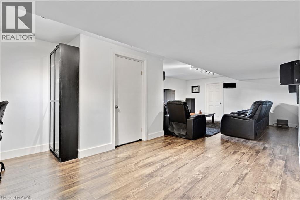 Recessed lighting, wood-finish flooring, white walls, and a built-in display cabinet - 7 Shadywood Lane, Cambridge, ON