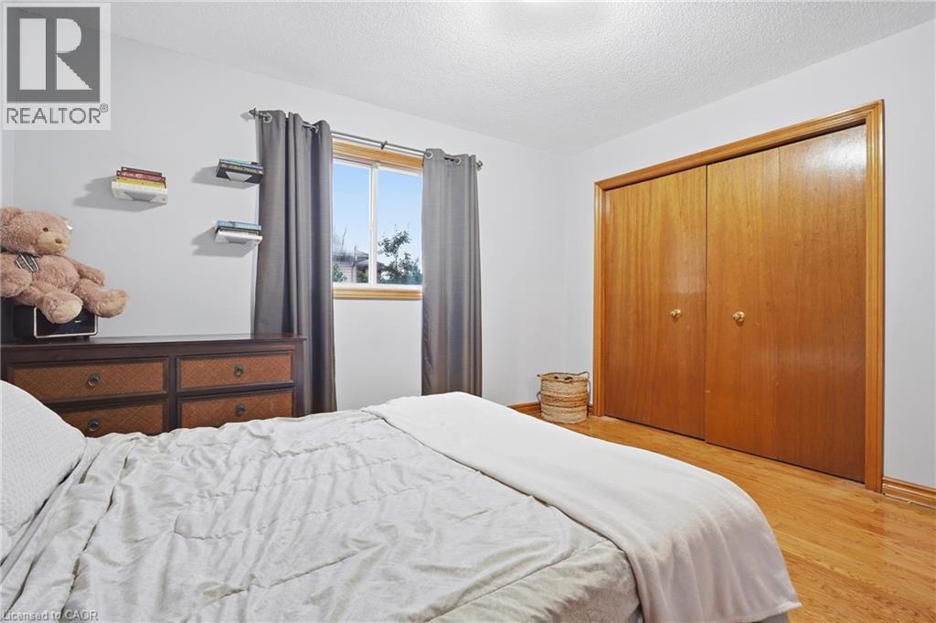 Wood-finish flooring with light-toned walls - 76 Madeira Crescent, Cambridge, ON