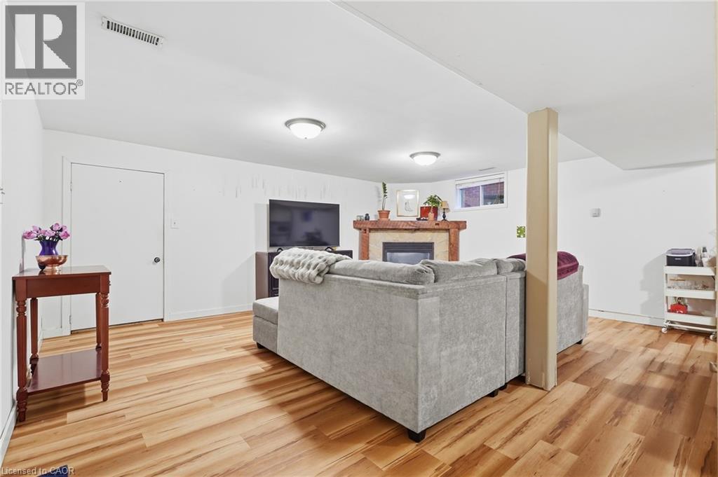 Recessed lighting illuminates wood-finish flooring - 76 Madeira Crescent, Cambridge, ON