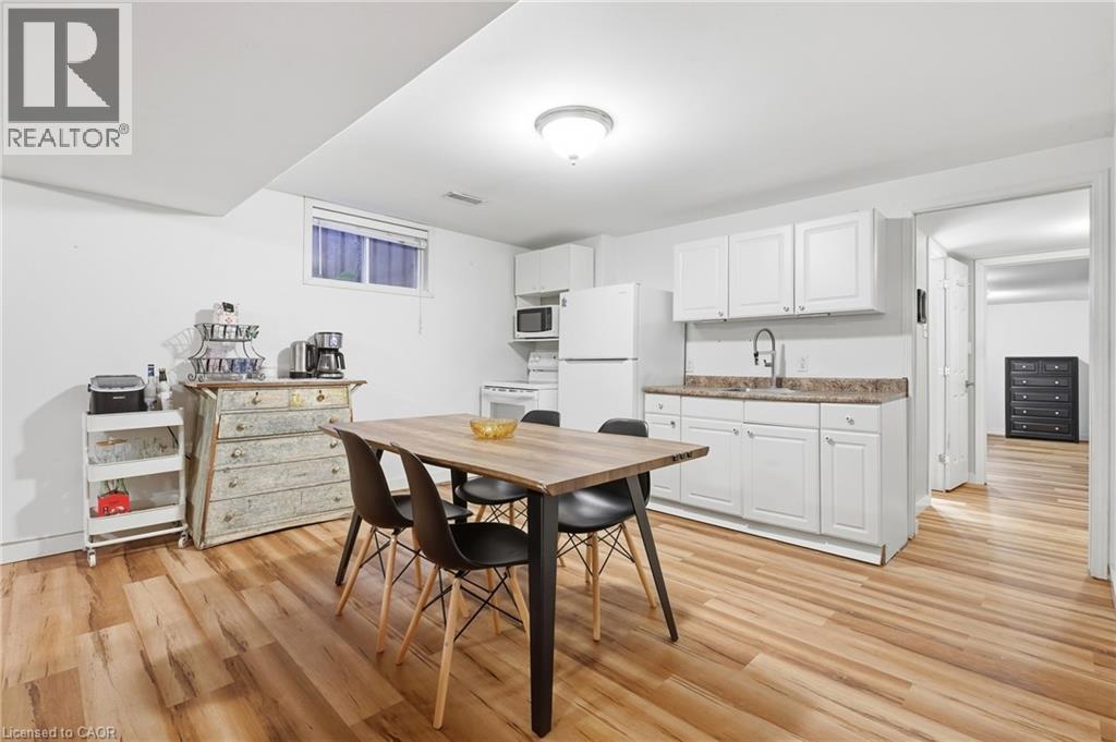 Full kitchen with white cabinetry, countertop, and a stainless steel sink - 76 Madeira Crescent, Cambridge, ON