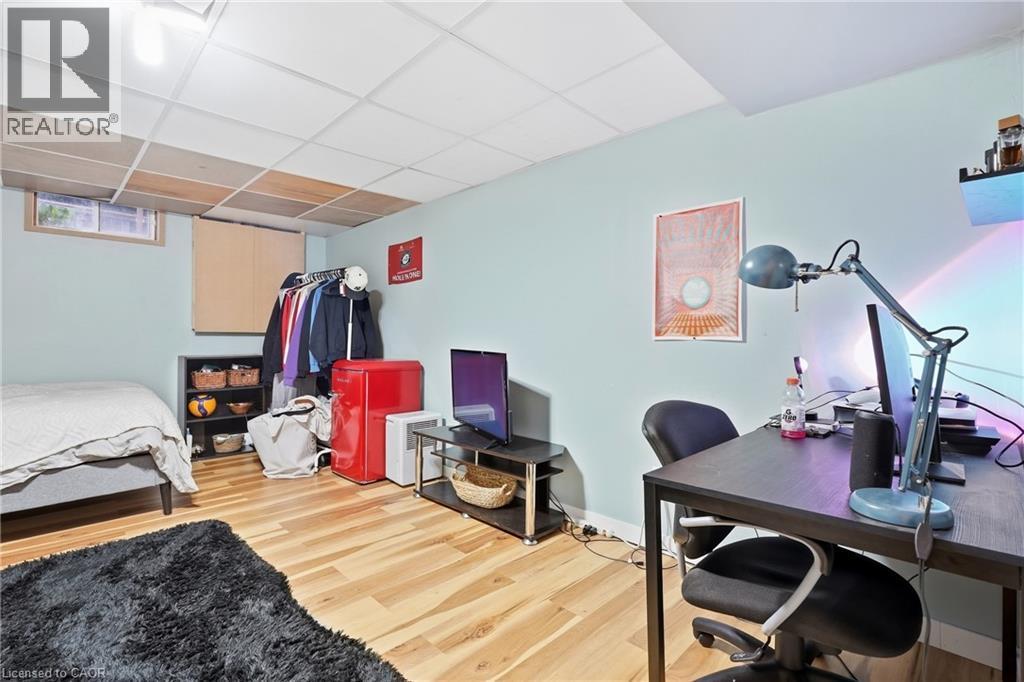Recessed lighting, wood-finish flooring, drop ceiling, light-toned walls, and a window with natural light - 76 Madeira Crescent, Cambridge, ON