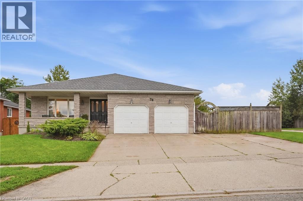 Stone veneer exterior with a covered front porch, double garage, asphalt shingle roof, and a concrete driveway - 76 Madeira Crescent, Cambridge, ON