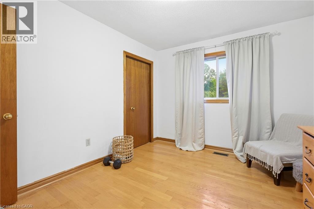 Hardwood flooring, natural wood doors, wood window trim, and white walls - 76 Madeira Crescent, Cambridge, ON