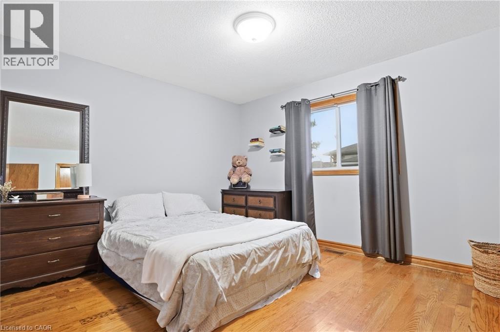 Hardwood flooring, painted walls, and window with wood trim - 76 Madeira Crescent, Cambridge, ON