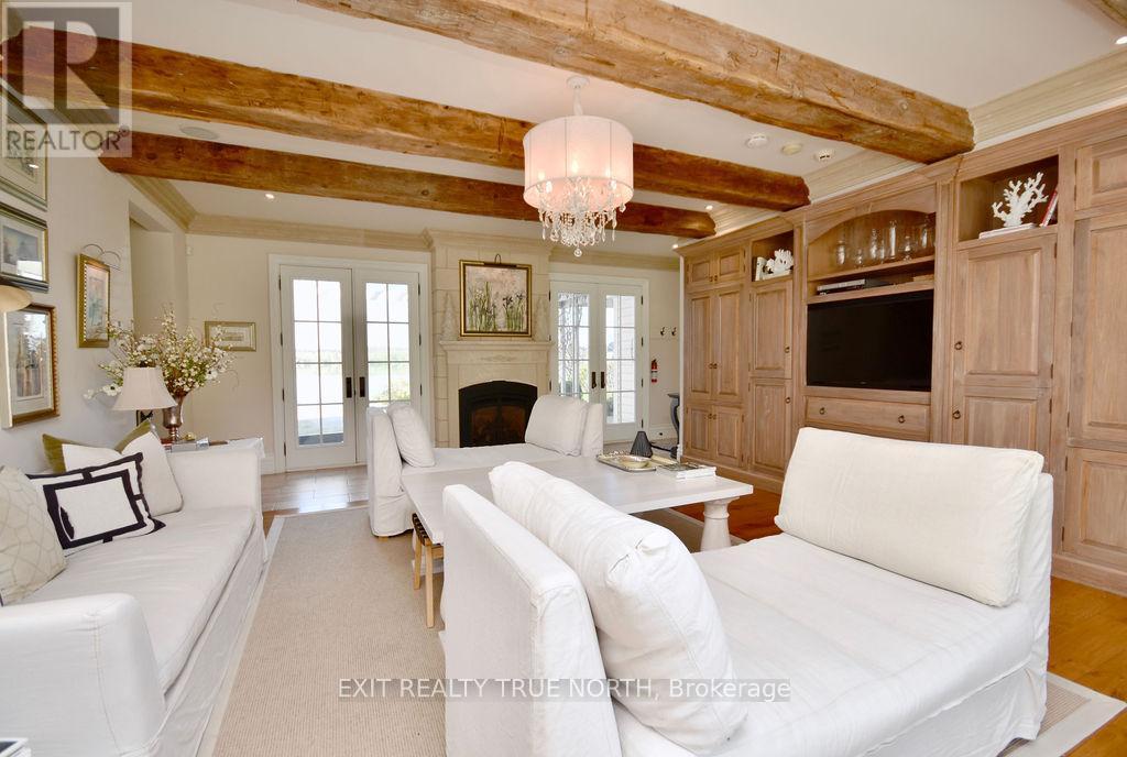 Inviting family room with custom built-ins - 3021 Sandy Bend, Springwater, ON