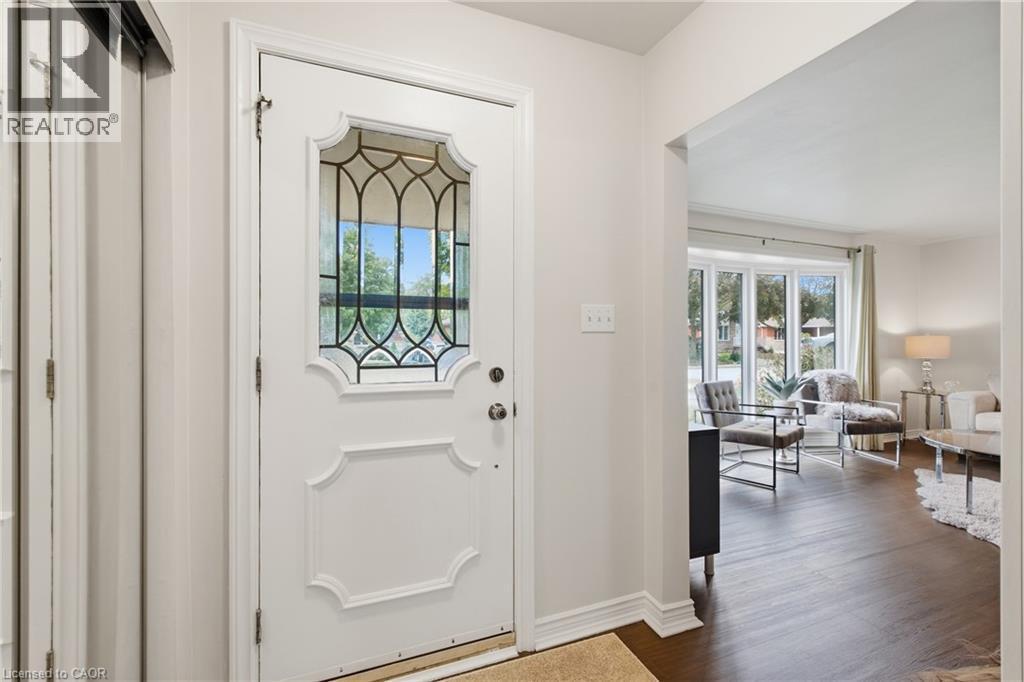 White entry door with decorative leaded glass panel - 22 Sycamore Street, Hamilton, ON
