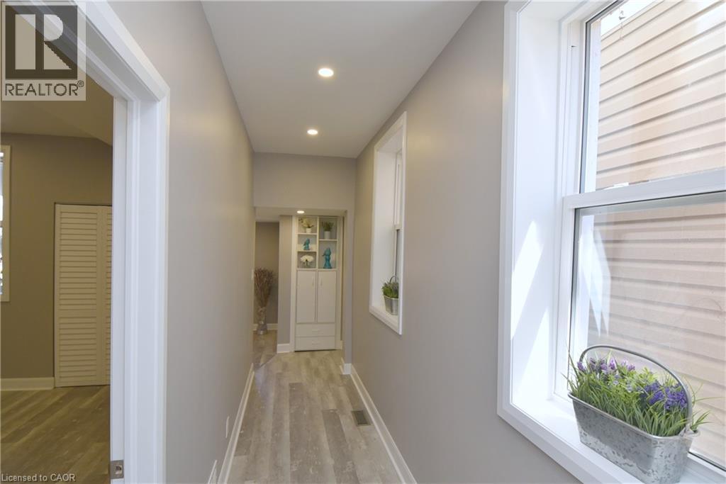 Recessed lighting illuminates wood-finish flooring - 76 Burlington Street E, Hamilton, ON