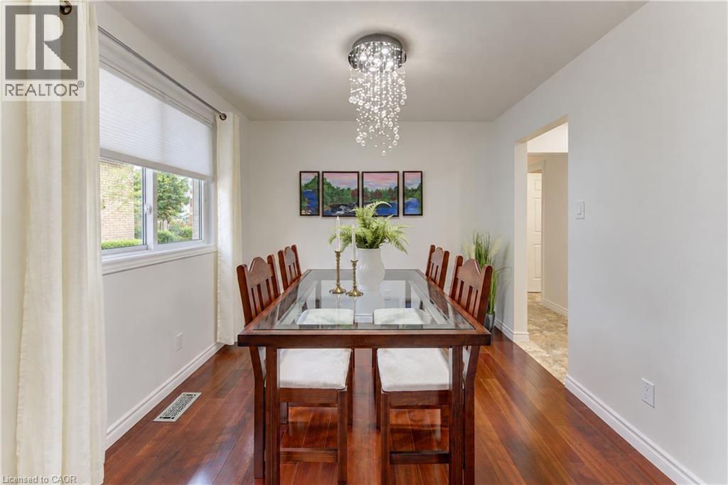 Hardwood-finish flooring, white walls, and a multi-pane window with cellular shades - 422 Grangewood Drive, Waterloo, ON