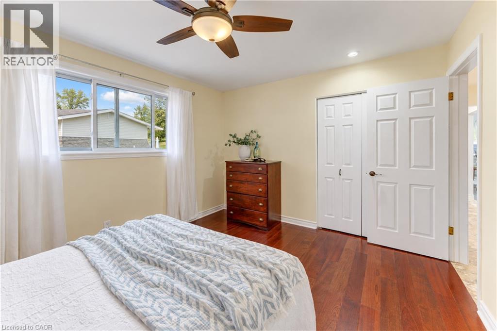 Hardwood flooring, white trim, ceiling fan, recessed lighting, and a double-panel door - 422 Grangewood Drive, Waterloo, ON
