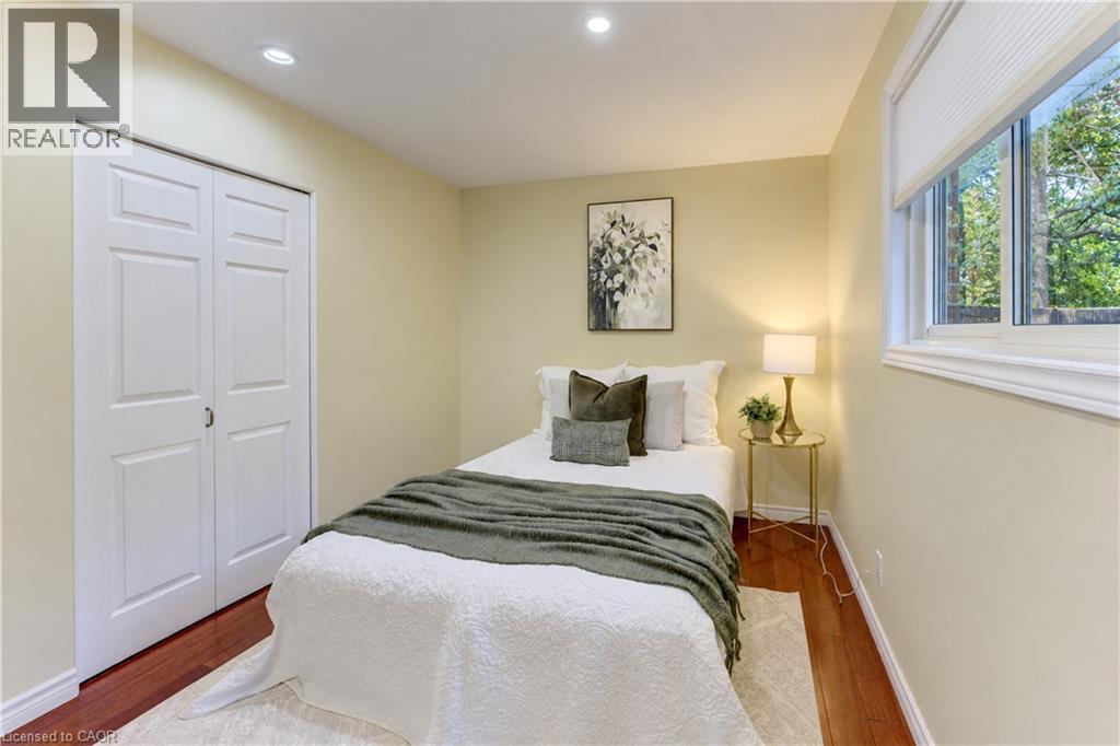 Recessed lighting, wood-finish flooring, white window trim, and a built-in closet with bi-fold doors - 422 Grangewood Drive, Waterloo, ON