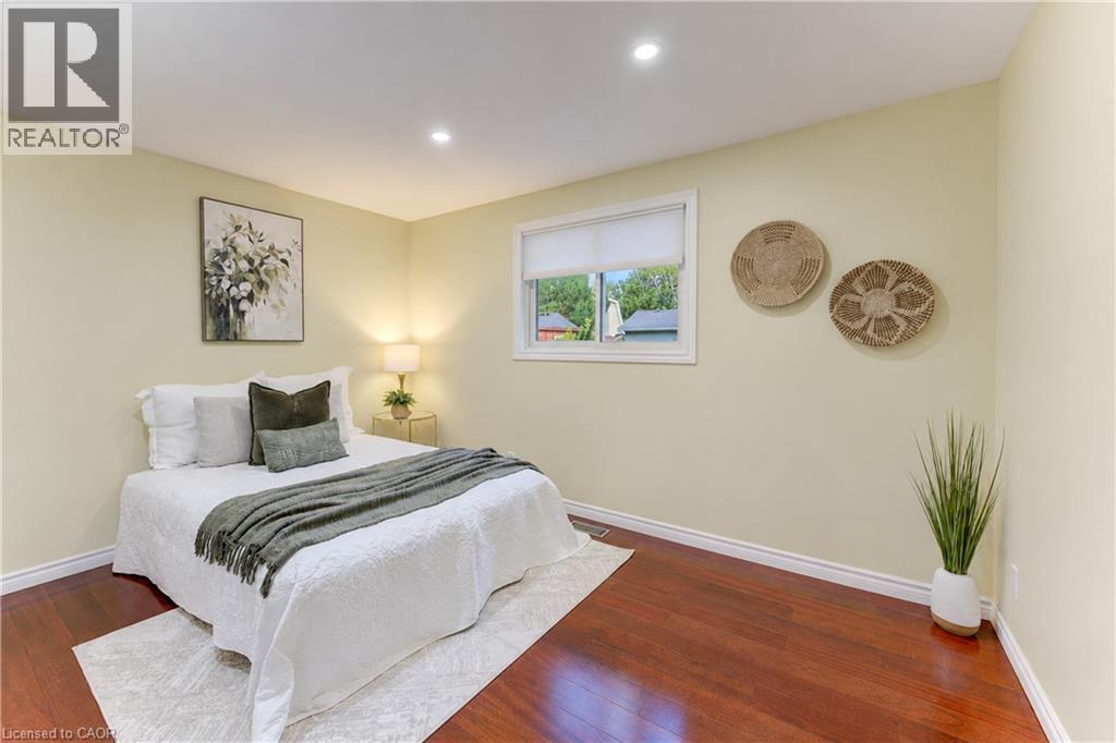 Recessed lighting, wood-finish flooring, and a window with a roller blind - 422 Grangewood Drive, Waterloo, ON