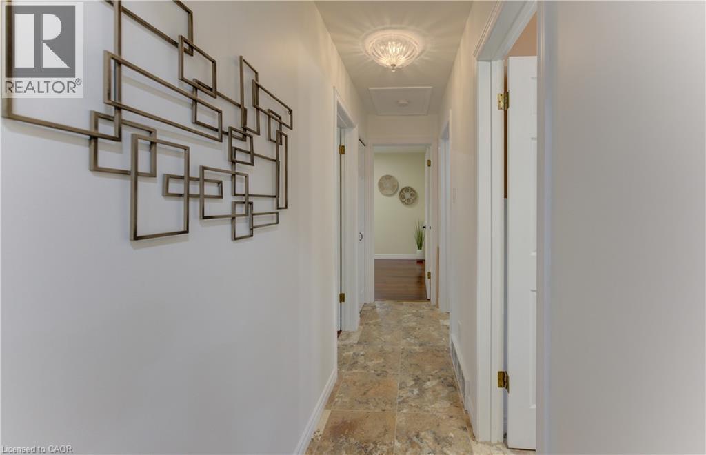 Recessed ceiling lighting, a decorative semi-flush mount light fixture, and tile flooring - 422 Grangewood Drive, Waterloo, ON