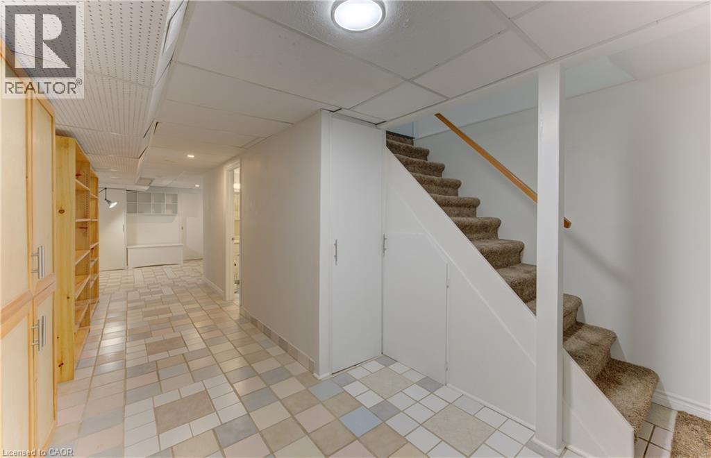 Tiled flooring, built-in shelving, white walls, drop ceiling, and recessed lighting - 422 Grangewood Drive, Waterloo, ON