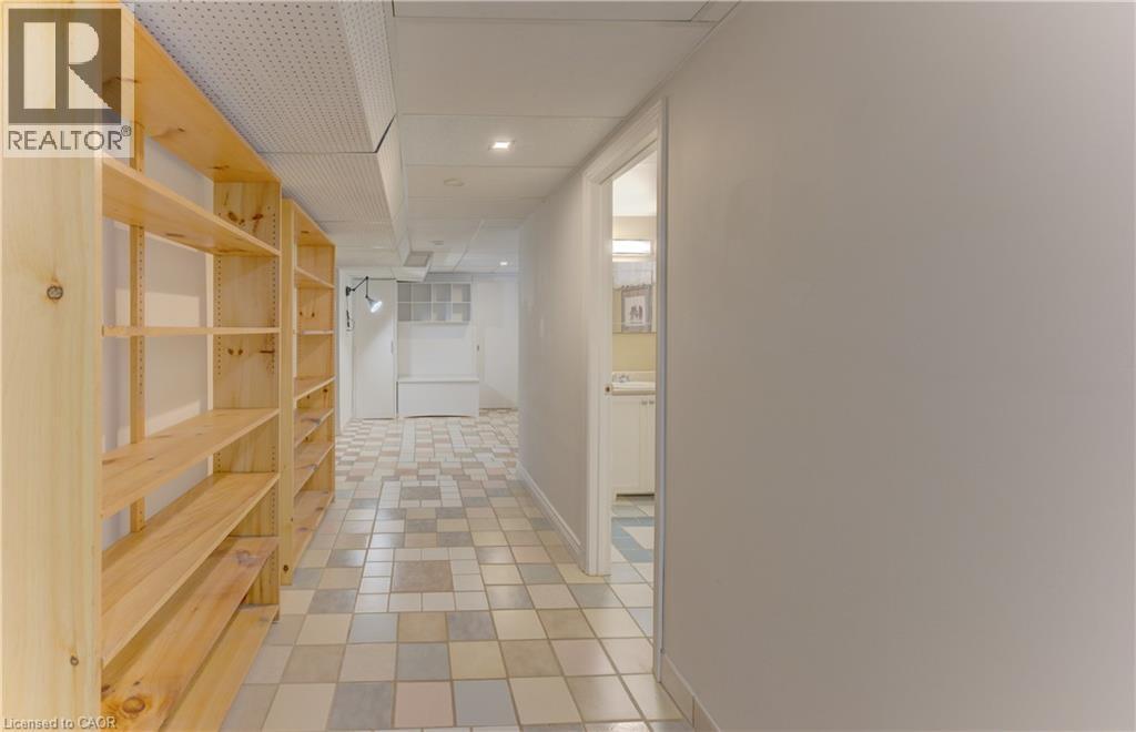 Built-in wood shelving, tiled flooring, recessed lighting, and a white drop ceiling - 422 Grangewood Drive, Waterloo, ON