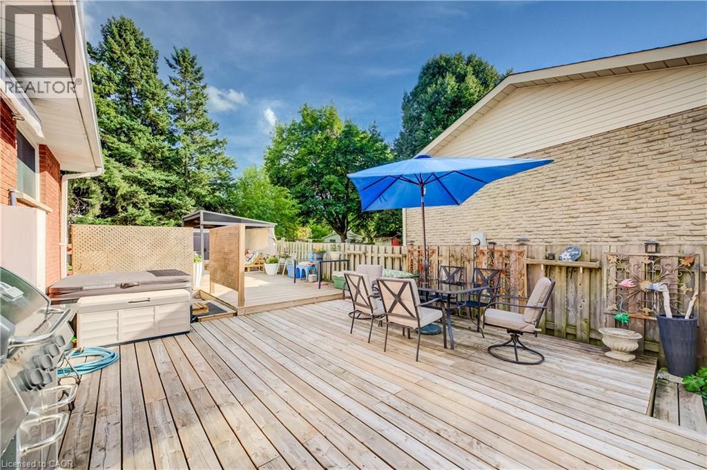 Expansive wood deck with a hot tub, a pergola, and a privacy screen - 422 Grangewood Drive, Waterloo, ON