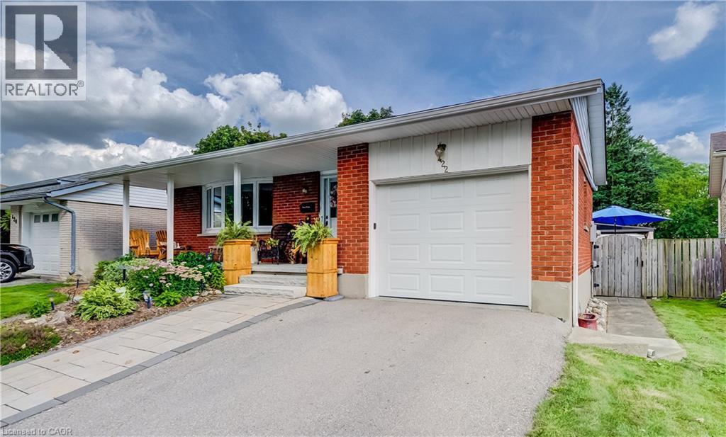 Brick exterior with an attached single-car garage, covered entry, and a paved driveway - 422 Grangewood Drive, Waterloo, ON